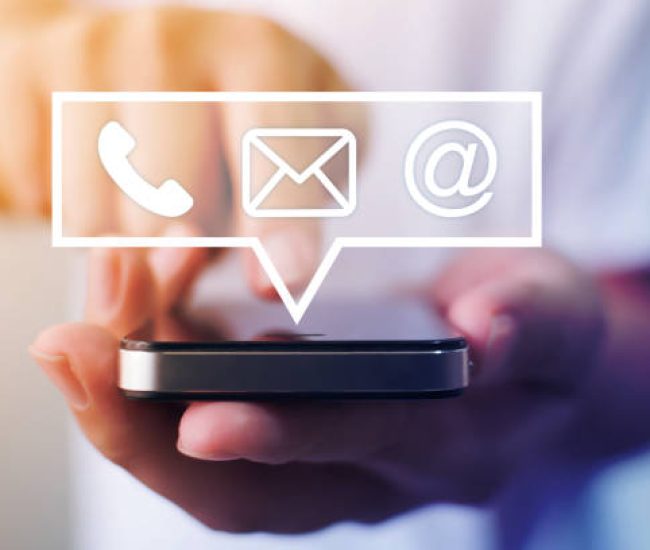 Close-up image of male hands using smartphone with icon telephone email mobile phone and address. Contact us connection and e-mail marketing concept